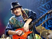 Carlos Santana coaxes sounds from his guitar during a show at the Philips Arena in Atlanta.