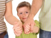 5-6 years old boy with his parents isolated on white